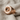 Audio Speaker Ring, rose gold plated, angled view on textured fabric