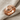 Tire Tread Ring in rose gold finish, product photo on linen