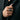 Close-up of oxidized silver plague doctor ring worn on finger paired with stylish dark jacket suit