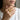 Model wearing a gold toned version of the sacred geometric maze ring on her index finger close up shot