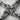 Extreme close-up of oxidized silver Brigid's Cross pendant highlighting expert artisan woven metalwork