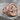 Winged bull faravahar signet ring, rose gold, front view on stone surface