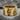 Skull Gear Ring, gold vermeil, front view on stone base