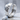 Rugged crater huggie hoop earring, polished, angled product view on stone