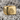 Double Triangle Pride Ring, gold vermeil, front view on textured stone
