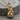 Astronaut on moon pendant, gold vermeil, front product view on wood