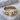 Molten droplet open ring, gold vermeil, front view on stone surface