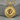 Molten Disc Pendant in gold vermeil, front view resting on stone