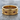 Fleur-de-lis Cross Band Ring, gold vermeil, product photo on stone surface