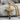 Twisted Rope Cross Pendant, gold vermeil, front view resting on stone