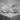 Forest Moon Wolf Cufflink, polished silver, front view on stone surface
