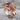 Rising Mermaid Ring, rose gold, angled view on textured stone