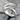 Embracing Hands Hug Ring, polished, product photo on stone surface