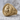 Flaming Sacred Heart Ring, gold vermeil, product photo on stone surface