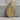 Skeleton Lovers Medallion Pendant, gold vermeil, front view on stone surface