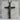 Halo Corpus Crucifix Pendant, black rhodium, on grey stone pedestal