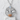 Baby Bat Pendant, polished silver, front view on display pedestal