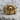 Coiled Snake Skull Ring, front view on stone display surface