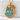 Sleeping Baby Dragon Pendant, gold vermeil, front view on textured stone