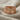 Last Supper Communion Ring, rose plated silver, front view on fabric