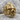 Melted skull ring in gold vermeil, angled front view on stone