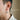Side view of model wearing a handcrafted sterling silver spider web drop earring with oxidized finish detail