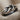 Infinity Knot Loop Ring in oxidized silver, angled view on linen