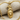 Eagle Wolf Totem Pendant, gold vermeil, front view on textured fabric