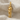 Dancing Couple Pendant, gold vermeil, front view on fabric