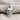 Military skull pendant, polished silver, front view on fabric
