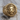 Scrollwork Lion Signet Ring, gold vermeil, front view on wood surface
