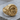 Alpha Omega Signet Ring, gold vermeil, angled view on wood
