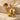 Mossy Skull Pendant, gold vermeil, three-quarter view on stone surface
