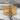 Superhero emblem ring, gold vermeil, front view on stone surface