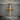 Wood Grain Cross Pendant, gold vermeil, product photo on stone surface