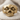 Zombie Skull Ring, gold vermeil, front product view on fabric