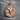 Bull Medallion Pendant, rose plated silver, front view on stone pedestal