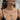 Woman wearing the anatomical ribcage caged heart pendant necklace with gold chain and black dress