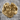 Abstract Chaos Ring, gold vermeil finish, front view resting on stone surface