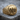 Three skulls ring, gold vermeil, product photo on wooden surface