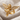 Praying Cherub Ring, gold vermeil, angled front view on fabric