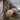 Lifestyle view of a man wearing the oxidized silver eagle feather ring outdoors on a wooden fence rail
