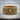Twin Serpent Skull Ring, gold vermeil, front view on wooden surface
