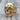 Anatomical skull jaw ring, gold vermeil, three-quarter view on wood