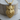 Tusked Wild Boar Pendant, gold vermeil, front view on wood base