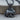 Crouching Rabbit Pendant, black rhodium, product photo on wood