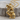 Thinker Statue Pendant, gold vermeil, angled product photo on wood