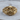 Helmet Winged Skull Ring, gold vermeil, front product view on wood