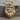 Mountain Bear Paw Pendant, gold vermeil, product photo on wood surface