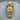 Beanie Skull Pendant, gold vermeil, product photo on wood